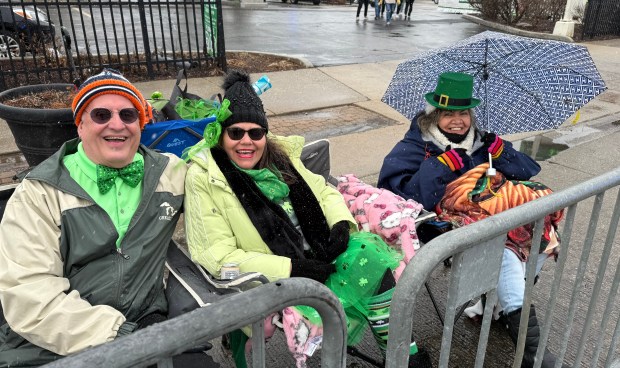 Chicago's Dave Madeck, left, Maria Comacho and Elvira Comacho stake out a spot 75 minutes before the start of the South Side Irish Parade March 16, 2025 in Chicago's Beverly neighborhood. (Jeff Vorva/for the Daily Southtown)