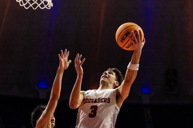 Brother Rice's Marcos Gonzales (3) lays the bal up against DePaul Prep during the Class 3A state championship game at the State Farm Center in Champaign on Saturday, March 15, 2025. (Vincent D. Johnson / for the Daily Southtown)