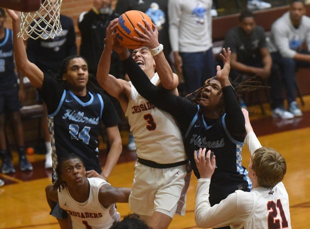 Brother Rice's Marcos Gonzales (3) comes down with the rebound against Hillcrest during the Class 3A Brother Rice Sectional semifinals Tuesday, March 4, 2025 in Chicago, IL. (Steve Johnston/for the Daily Southtown)