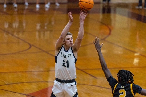 Lemont's Gabriel Sularski (21) shoots for three against Marian Catholic during the Class 3A Brother Rice Sectional semifinals in Chicago on Wednesday, March 5, 2025. (Vincent D. Johnson / for the Daily Southtown)