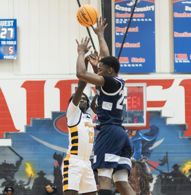 St. Laurence's Caleb Lindsey (12) shoots the ball against Hyde Park during a Class 3A Glenbard South Sectional semifinal game in Glen Ellyn on Tuesday March 4, 2025. (Troy Stolt for the Daily Southtown)