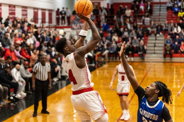 Marist's Karson Thomas (4) hits a fade-away jumper against Sandburg during the Class 4A Marist Regional final in Chicago on Friday, Feb. 28, 2025. (Vincent D. Johnson / for the Daily Southtown)