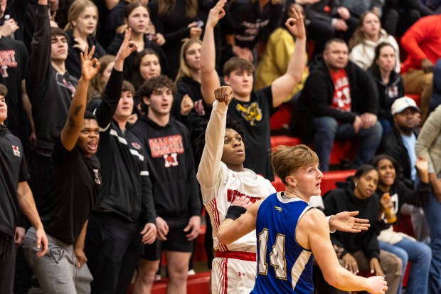 Marist's TJ Tate (2) watches as he sinks a 3-pointer against Sandburg during the Class 4A Marist Regional final in Chicago on Friday, Feb. 28, 2025. (Vincent D. Johnson / for the Daily Southtown)