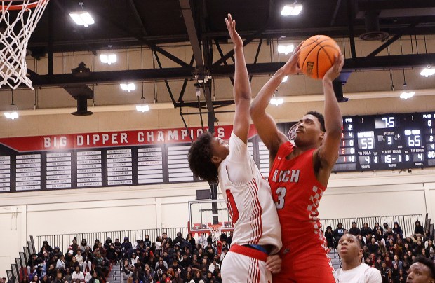 Rich Township's Jamson Coulter (right) puts up a shot over Marist's Kendall Meyers (left) during a Class 4A Rich Township Sectional semifinal basketball game on Wednesday March 5, 2025.(John Smierciak / Daily Southtown)