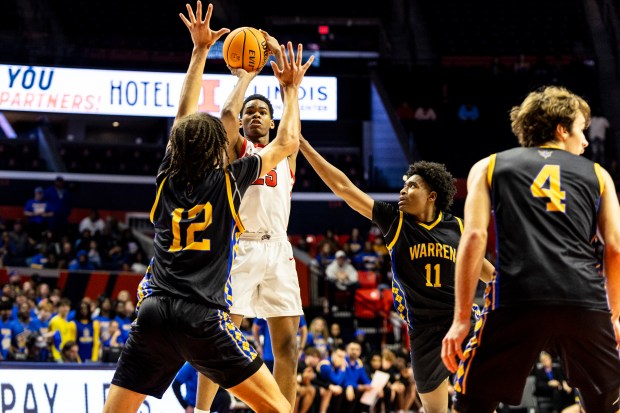 Rich Township's Jayden Williams (25) puts up a jump shot over Warren Township's Zach Ausburn (12) during the Class 4A state semifinal at State Farm Center in Champaign on Friday, March 14, 2025. (Vincent D. Johnson / for the Daily Southtown)