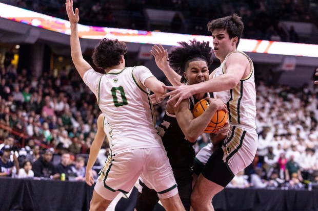 Mount Carmel's Noah Mister (2) gets tripped up by a pair of St. Patrick players during the Class 3A Illinois-Chicago Supersectional at Credit Union 1 Arena in Chicago on Monday, March 10, 2025. (Vincent D. Johnson / for the Daily Southtown)