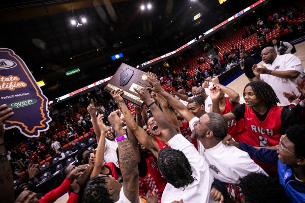 Rich Township's Nyshawn Turner lifts up the plaque for the Class 4A Illinois-Chicago Supersectional championship after they defeated Kenwood in overtime at Credit Union 1 Arena in Chicago on Monday, March 10, 2025. (Vincent D. Johnson / for the Daily Southtown)