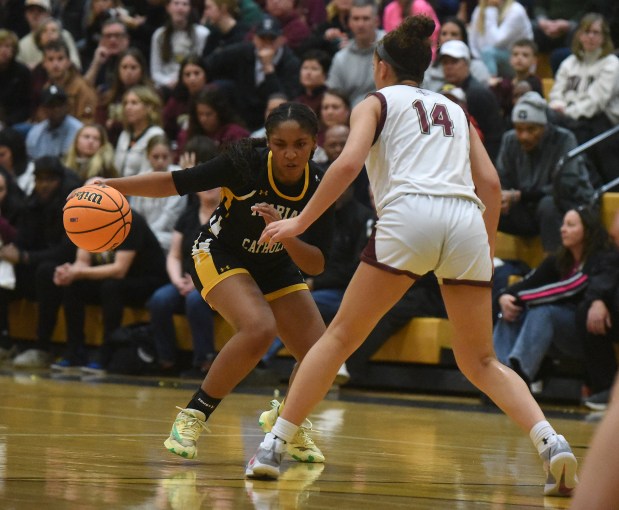 Marian Catholic's Alainna Poisson (11) drives to the basket against St. Ignatius' Isabella Keberlein (14) during the Class 3A Hinsdale South Supersectional Monday, March 3, 2025 in Darien, IL. (Steve Johnston/for the Daily Southtown)