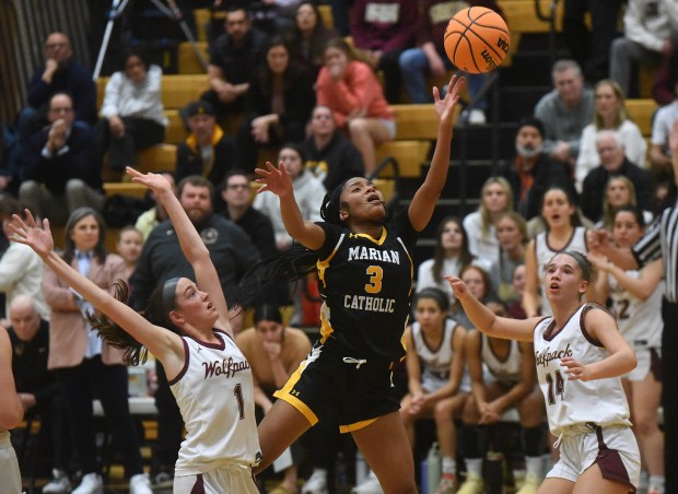 Marian Catholic's Taylor Bolton (3) lays in a shot against St. Ignatius during the Class 3A Hinsdale South Supersectional Monday, March 3, 2025 in Darien, IL. (Steve Johnston/for the Daily Southtown)