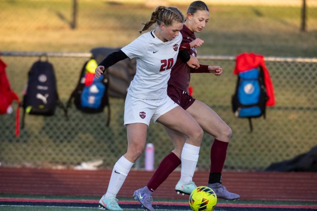 Lincoln-Way Central's Abby Sudkamp (20) battles for the ball with Lockport's Ava Kozak (6) during a Windy City Ram Classic second-round game in New Lenox on Thursday, March 20, 2025. (Vincent D. Johnson / for the Daily Southtown)