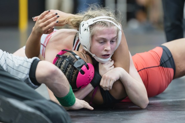 Lockport's Claudia Heaney wrestles Glenbard East's Maria Green during the 135 pound championship match of the Hinsdale South Regional on Saturday, Feb. 1, 2025. (Troy Stolt / for the Daily Southtown)