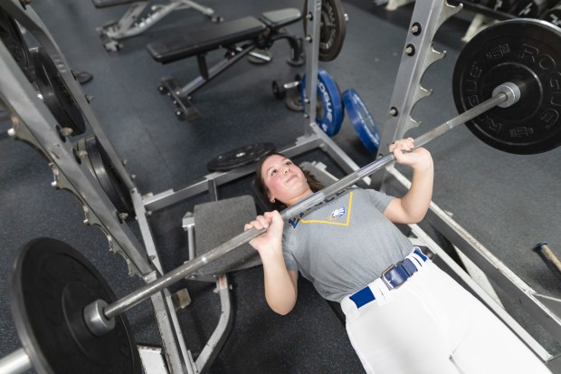 Sandburg's Gianna Shoenecker (1) bench presses during a team lift in Orland Park on Wednesday March 19, 2025. (Troy Stolt for the Daily Southtown)