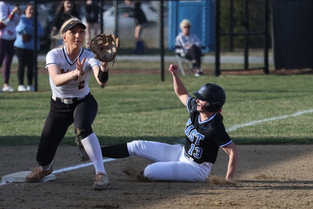 Lincoln-Way East's Mia Balta (13) slides into third base against St. Laurence during a non conference game in Frankfort on Monday March 17, 2025. (Troy Stolt for the Daily Southtown)