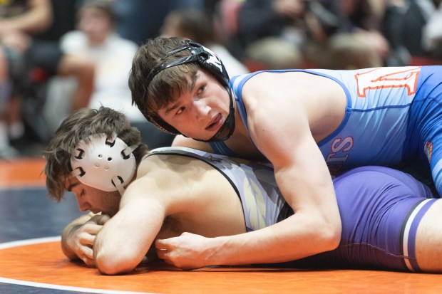 Marmion's Ashton Hobson wrestles Hononegah's Max Aranki during their 157 pound match in the IHSA 3A wrestling state dual tournament final in Bloomington on Saturday, March 1, 2025. (Troy Stolt / for the Daily Southtown)