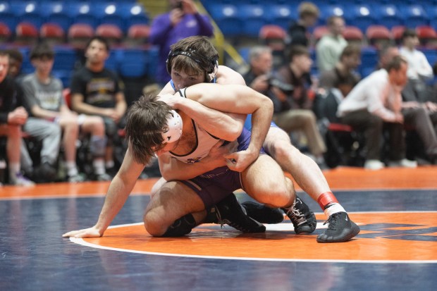 Marmion's Ashton Hobson wrestles Hononegah's Max Aranki during their 157 pound match in the IHSA 3A wrestling state dual tournament final in Bloomington on Saturday, March 1, 2025. (Troy Stolt / for the Daily Southtown)