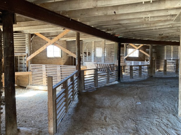 Stalls at the Manhattan Round Barn in Will County line the outer wall of the large structure, built to accomodate new technology that would ease livestock feeding from hay stored on its upper levels. (Paul Eisenberg/Daily Southtown)