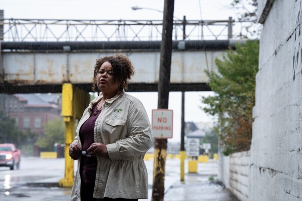 Gary activist Kimmie Gordon near the entrance of Gary Works, one of the nation's biggest polluters, Oct. 13, 2023. She and other residents formed Gary Advocates for Responsible Development to oppose projects like a trucking hub in the west side neighborhood where Gordon grew up, or a gasification plant to turn Chicago's plastic trash into fuel. (E. Jason Wambsgans/Chicago Tribune)