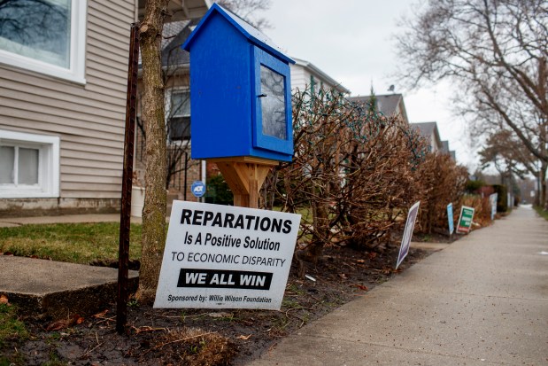 A pro-reparations sign sits outside a home in the 5th Ward on March 23, 2021, in Evanston. Aldermen approved the first expenditures in the city's municipal reparations program designed to compensate Black residents for codified discrimination. (Armando L. Sanchez/ChicagoTribune)