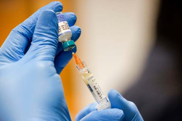 A nurse mixes a dose of the measles, mumps and rubella vaccine at a pop-up clinic at the Carrollton-Farmers Branch ISD Administration Building in Carrollton, Texas, on March 7, 2025. (Liz Rymarev/The Dallas Morning News)