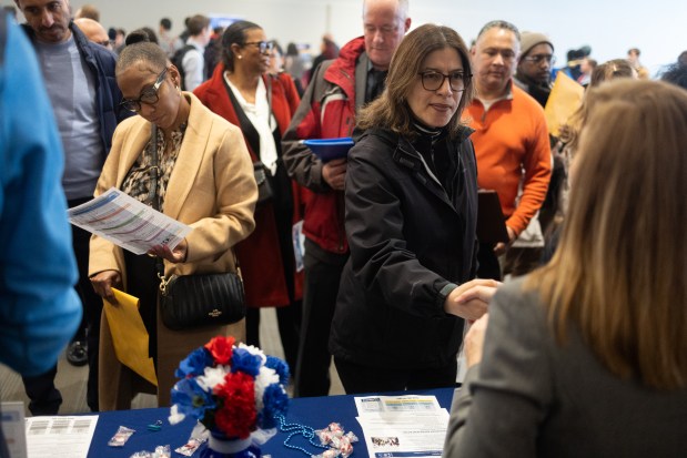 Diana Diaz, right, shakes hands with Sudi Garcia, with the Illinois Department of of Employment Security, during the State of Illinois Malcom X College Spring Career Fair on March 20, 2025. (Audrey Richardson/Chicago Tribune)