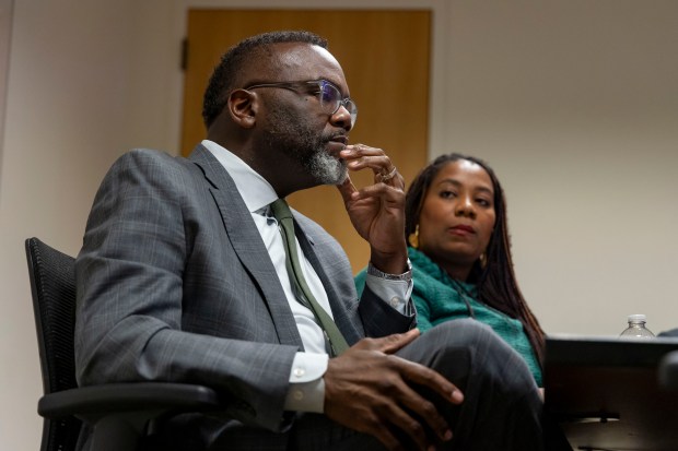 Mayor Brandon Johnson, seated alongside Budget Director Annette Guzman, meets with the Tribune Editorial Board to discuss the budget and other issues on Oct. 31, 2024, at City Hall. (Brian Cassella/Chicago Tribune)