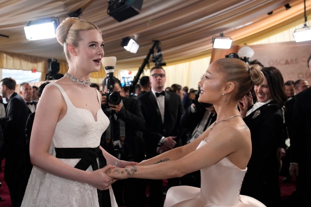 Elle Fanning, left, and Ariana Grande arrive at the Oscars on March 2, 2025, at the Dolby Theatre in Los Angeles. (John Locher/AP)