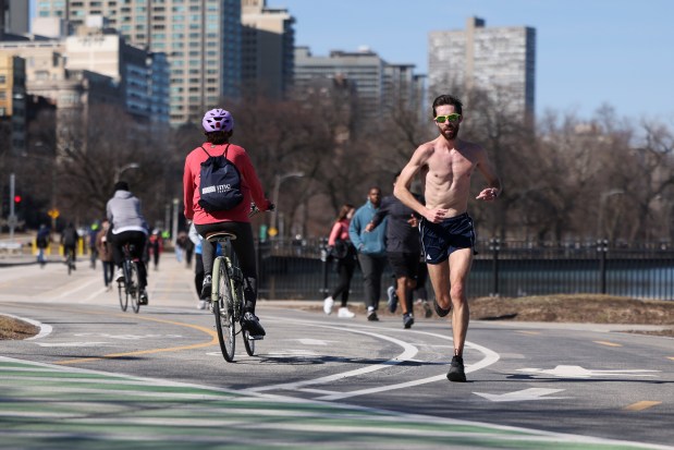 People run, bike, and walk along Belmont Harbor on March 9, 2025. (Eileen T. Meslar/Chicago Tribune)