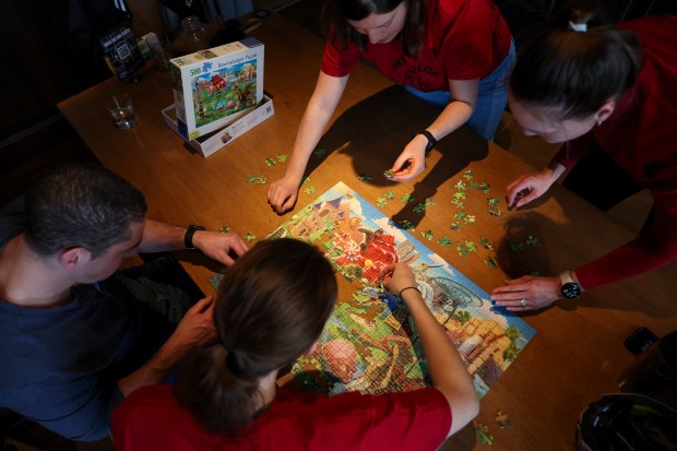 David Gonzalez, from left, Andrea Bryson, Laura Still, and Kim Hedlin compete in a monthly puzzle race at Snakes & Lattes Chicago in Logan Square. (Eileen T. Meslar/Chicago Tribune)