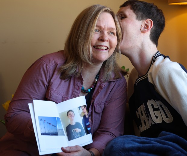 Braxton Farr, 24, left, whispers something in his mom Rachel Hellenga's ear at their home in Elmhurst on Feb. 10, 2025. (Stacey Wescott/Chicago Tribune)