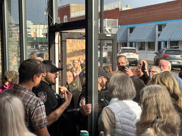 During a town hall with U.S. Rep. Mark Alford in Belton, Missouri on Feb. 24, 2025, police officers have a brief confrontation with the crowd outside as they attempted to close the door. (Jonathan Shorman/The Kansas City Star)