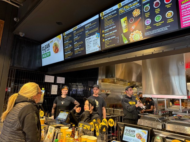 At the recently-opened Guzman y Gomez fast food restaurant at 1710 Sherman in downtown Evanston, Lara Thom, Guzman y Gomez' global chief marketing officer, orders from Nia Montoya. Employee Vivian Ransom is at left and Peter Geraerts, head of U.S. operations, is to Montoya's immediate right. The chain was started in Australia by an American. (Pam DeFiglio/Chicago Tribune)