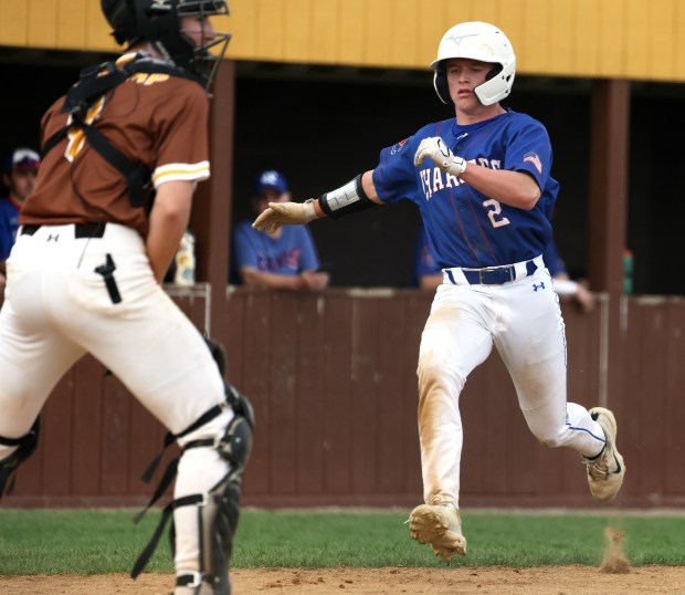 Dundee-Crown's Logan Gutierrez (2) scores a run on a hit by Ryan Pierce as Jacobs' Luke Flaskcamp (9) waits for the throw in the sixth inning during a Fox Valley Conference game against Jacobs in Algonquin on Thursday, April 24, 2025.(H. Rick Bamman/for the Beacon-News)