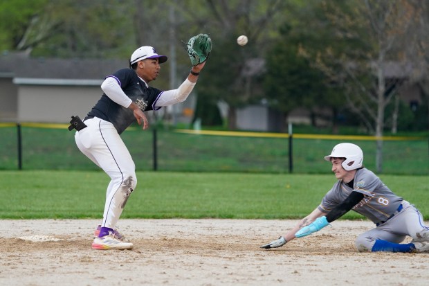 Plano's Jason Phillips, left, covers second base on a steal attempt by Somonauk's Silas Johnson (8) during a nonconference baseball game at Somonauk High School on Friday, April 25, 2025. (Sean King / for The Beacon-News)