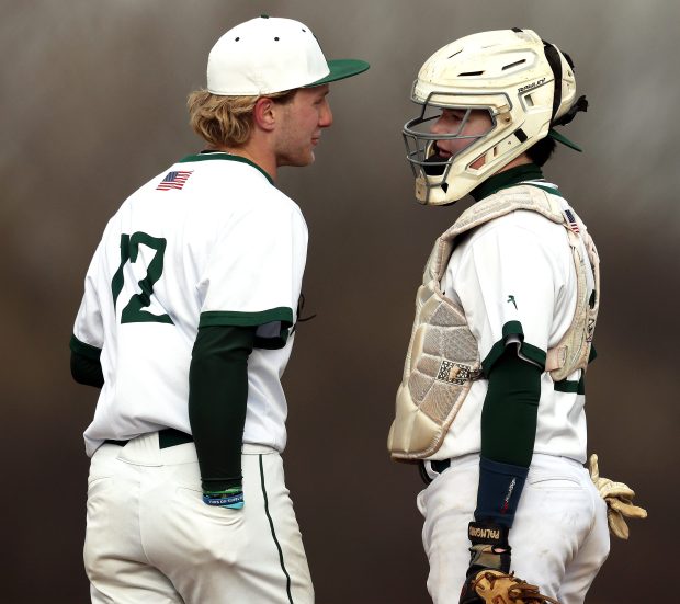 Bartlett's Vince Yario (12) and Alex Bihun (22) talk on the mound in the second inning during an Upstate Eight conference game against Streamwood in Bartlett on April 7, 2025.(H. Rick Bamman/for the Beacon-News)