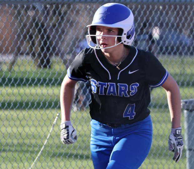 St. Charles North's Adeline Umlauf (4) takes off from third base against West Aurora girls softball during a non-conference game on Monday, April, 8, 2024. St. Charles North won, 13-0.H. Rick Bamman / For the Beacon News