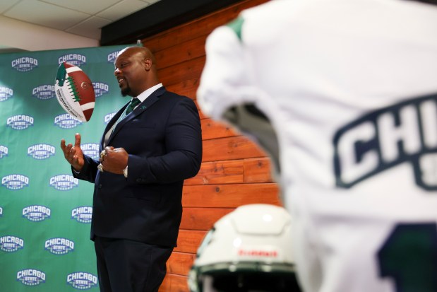Newly hired football coach Bobby Rome II poses with a football during a press conference to introduce the university's first football program at Chicago State University on April 8, 2025.(Eileen T. Meslar/Chicago Tribune)
