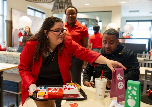 Franchise owner Elise Mills delivers a customer order April 17, 2025, on opening day at a Chick-fil-A restaurant in Chicago's Pullman neighborhood. (Brian Cassella/Chicago Tribune)