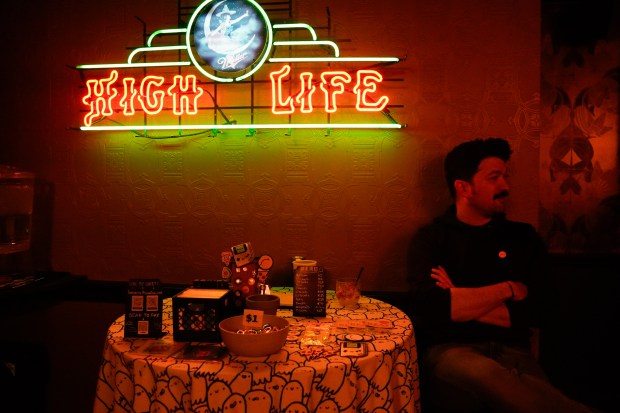 A table with work from artist Luis Romero can be seen during the "Welcome to the Show" variety show at The Getaway on April 7, 2025. (Addison Annis/for the Chicago Tribune)