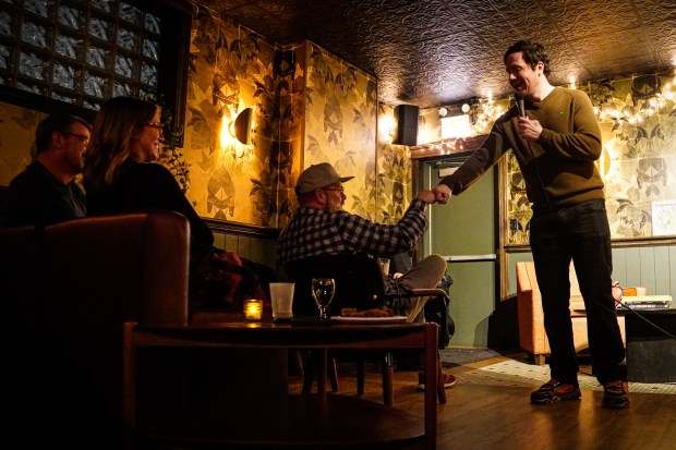 Cam Gillette fist-bumps a crowd member during the "Welcome to the Show" variety show at The Getaway in Chicago on April 7, 2025. (Addison Annis/for the Chicago Tribune)