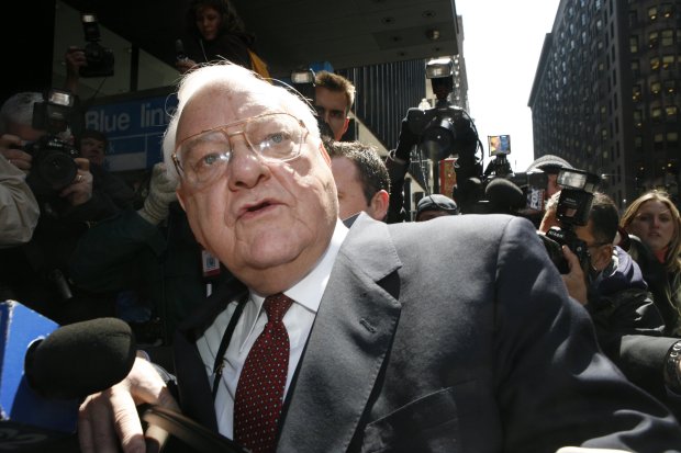 Former Illinois Gov. George Ryan makes his way past photographers and reporters as he gets into a car outside the Dirksen Federal Building on April 17, 2006. Ryan and co-defendant Larry Warner were found guilty on all counts in their federal corruption trial in Chicago. (José Moré/Chicago Tribune)