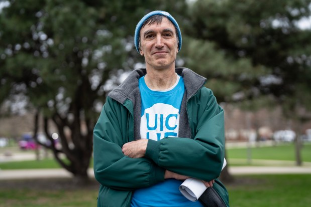 Michael Scott, associate professor of mechanical and industrial engineering, poses for a portrait during the Day of Action for Higher Ed at the UIC University Hall lawn on April 16, 2025. (E. Jason Wambsgans/Chicago Tribune)