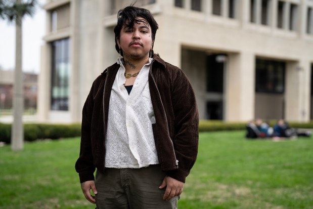 UIC grad Tichike Tumalan representing the UIC trans empowerment center at the UIC University Hall lawn during at the Day of Action for Higher Ed on April 16, 2025. (E. Jason Wambsgans/Chicago Tribune)