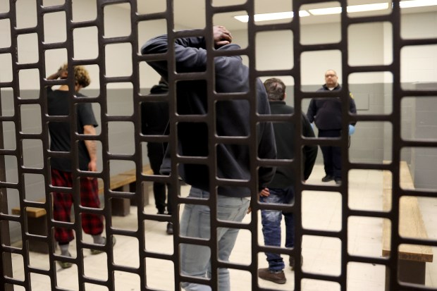Arriving detainees wait in a holding cell in an underground tunnel at the Cook County Jail in Chicago on April 16, 2025. The tunnels run underground to the Leighton Criminal Court Building. (Antonio Perez/Chicago Tribune)