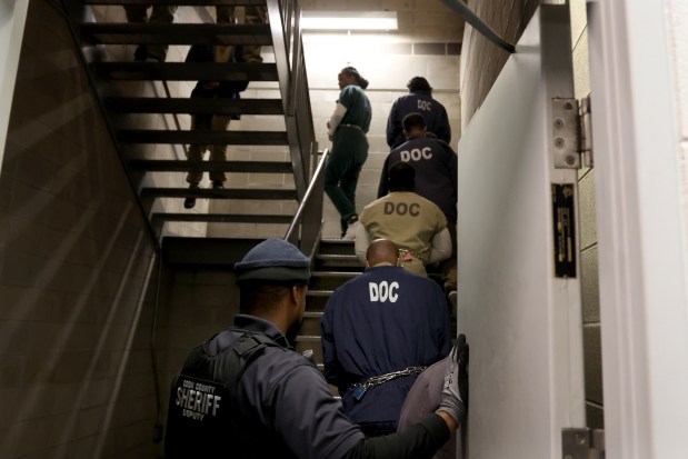 Inmates at Cook County Jail walk to a bus April 16, 2025, waiting to take them to various courthouses in Cook County. (Antonio Perez/Chicago Tribune)