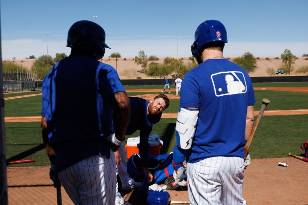 Chicago Cubs third base Gage Workman (25) looks up at Chicago Cubs infielder Justin Turner (3), right, at spring training at Sloan Park Friday Feb. 21, 2025, in Mesa, Arizona. (Armando L. Sanchez/Chicago Tribune)