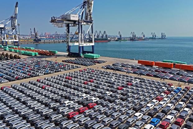 An aerial view of new cars waiting for shipment at a pier for ro-ro ships in Yantai city in eastern China's Shandong province Sunday, March 30, 2025. (Chinatopix Via AP) CHINA OUT