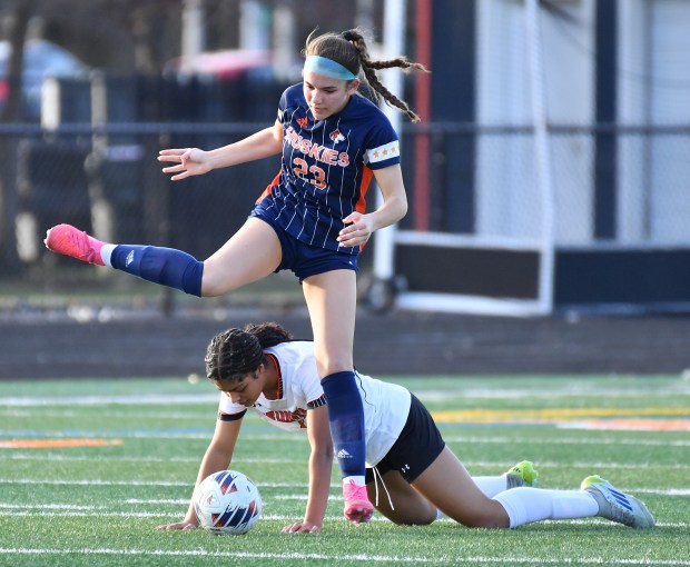 Naperville North's Addison Sitzman hurdles Edwardsville's Gabby Thompson