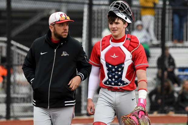 Crown Point assistant Dave Hoffman, talks with catcher Sean Dunlap