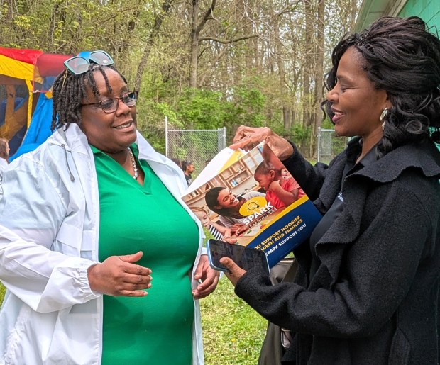 Nina Burton, left, director of the Woodland Child Development Center, talks with Dr. Alice Miller of Indiana Spark Learning Lab on Wednesday during a grand opening for the center in Gary. (Carole Carlson/for Post-Tribune)