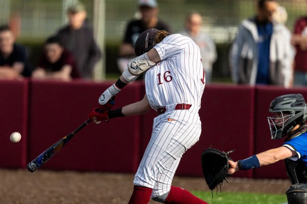 Brother Rice's Gavin Triezenberg (16) connects on a pitch from Lincoln-Way East during a nonconference game in Chicago on Tuesday, April 22, 2025. (Vincent D. Johnson / for the Daily Southtown)